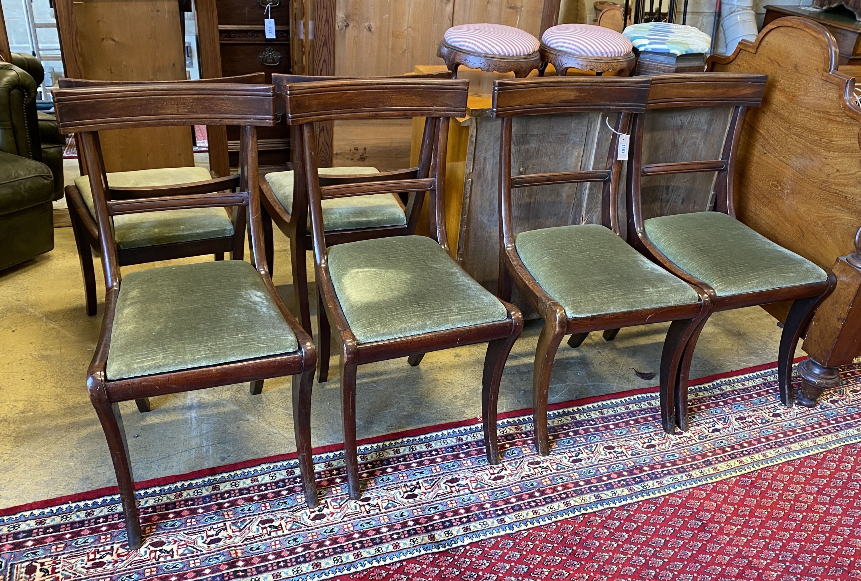 A set of six Regency mahogany sabre leg dining chairs